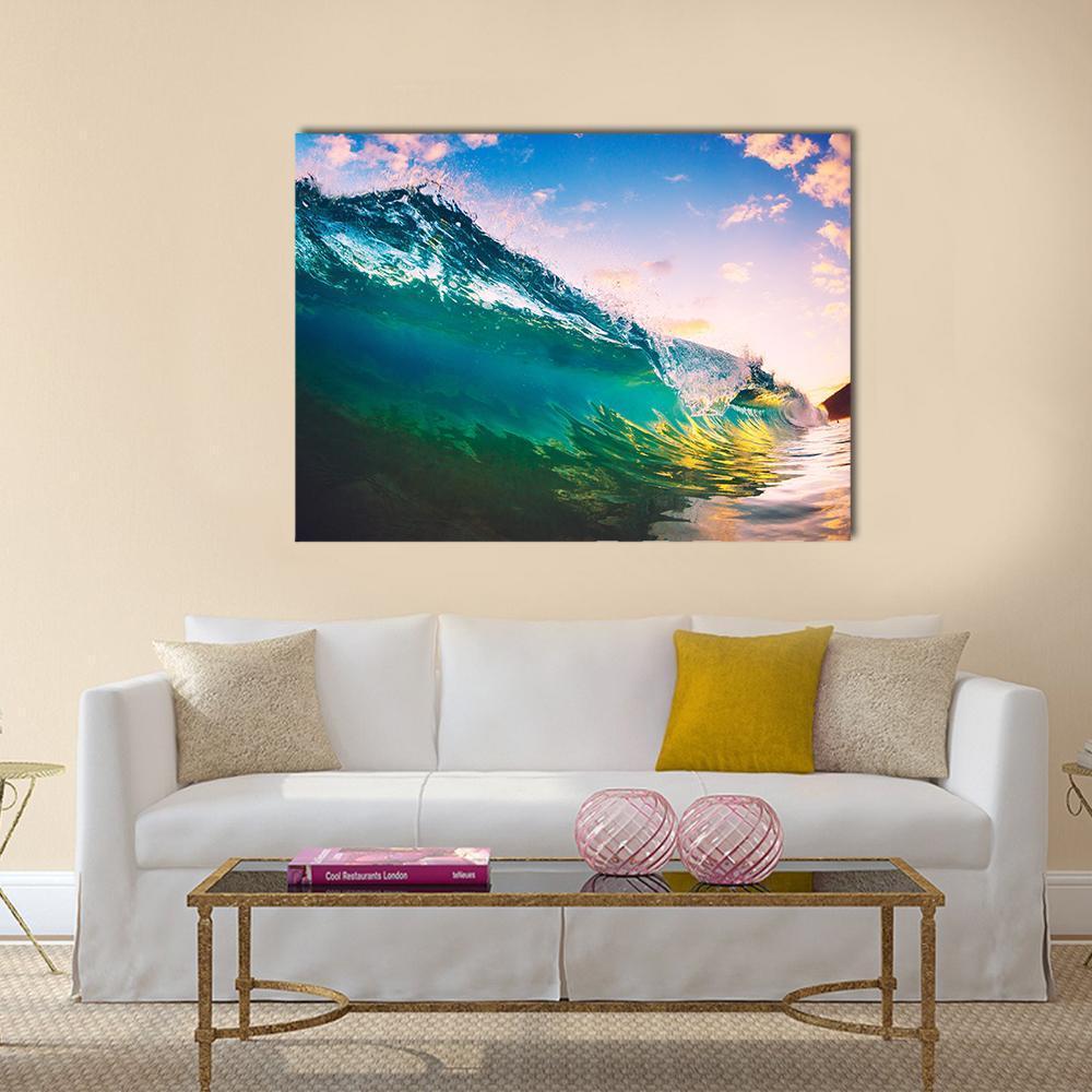 Ocean Wave at Sunset Canvas Wall Art in orange, yellow and blue, single panel hung on a wall