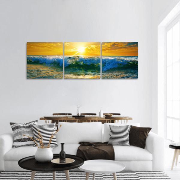 Golden Sunrise Breaking Wave Panoramic Canvas Wall Art in gold, yellow and blue, hung on a wall