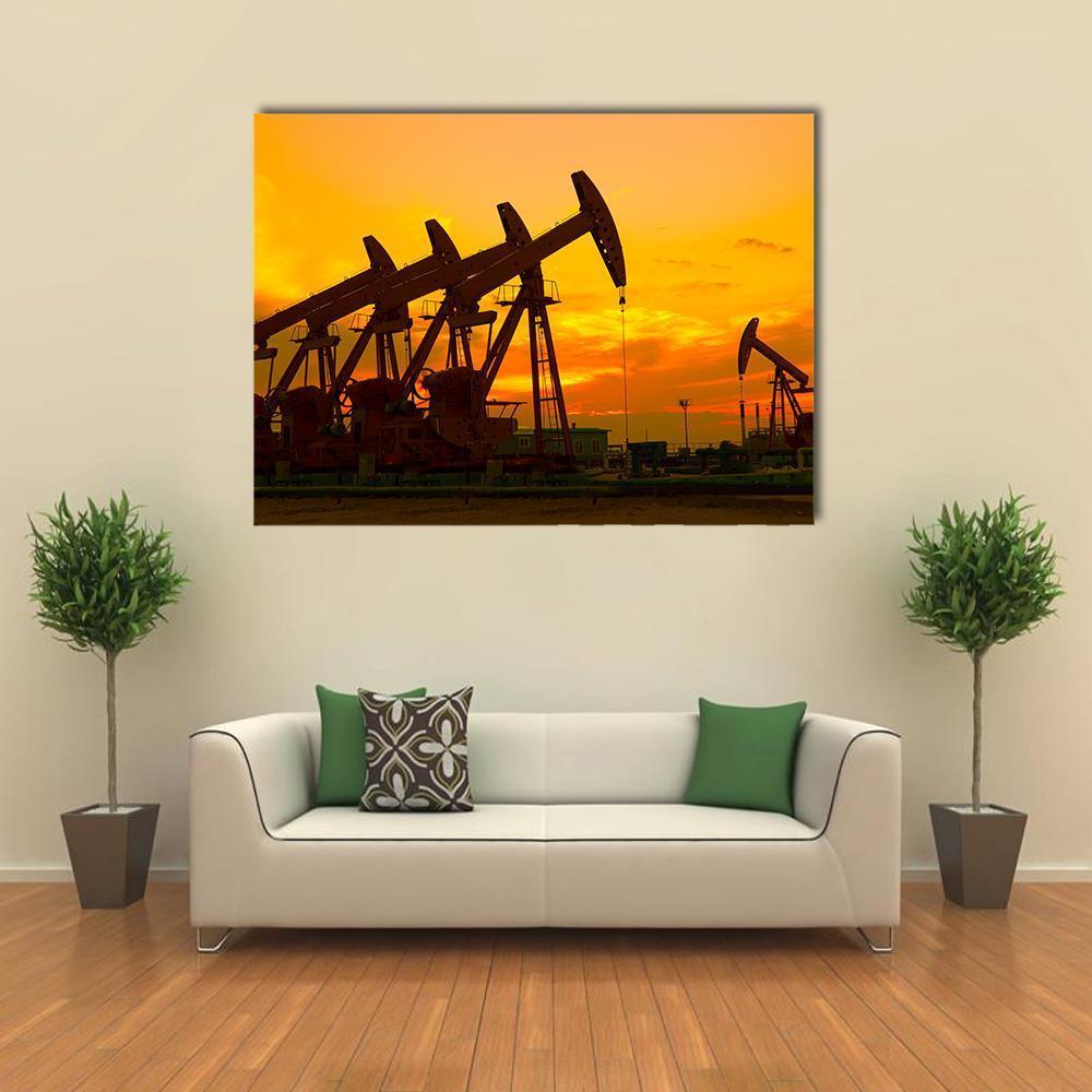 Oil Pumpjacks at Orange Sunset Canvas Wall Art in black, orange and yellow, single panel hung on a wall