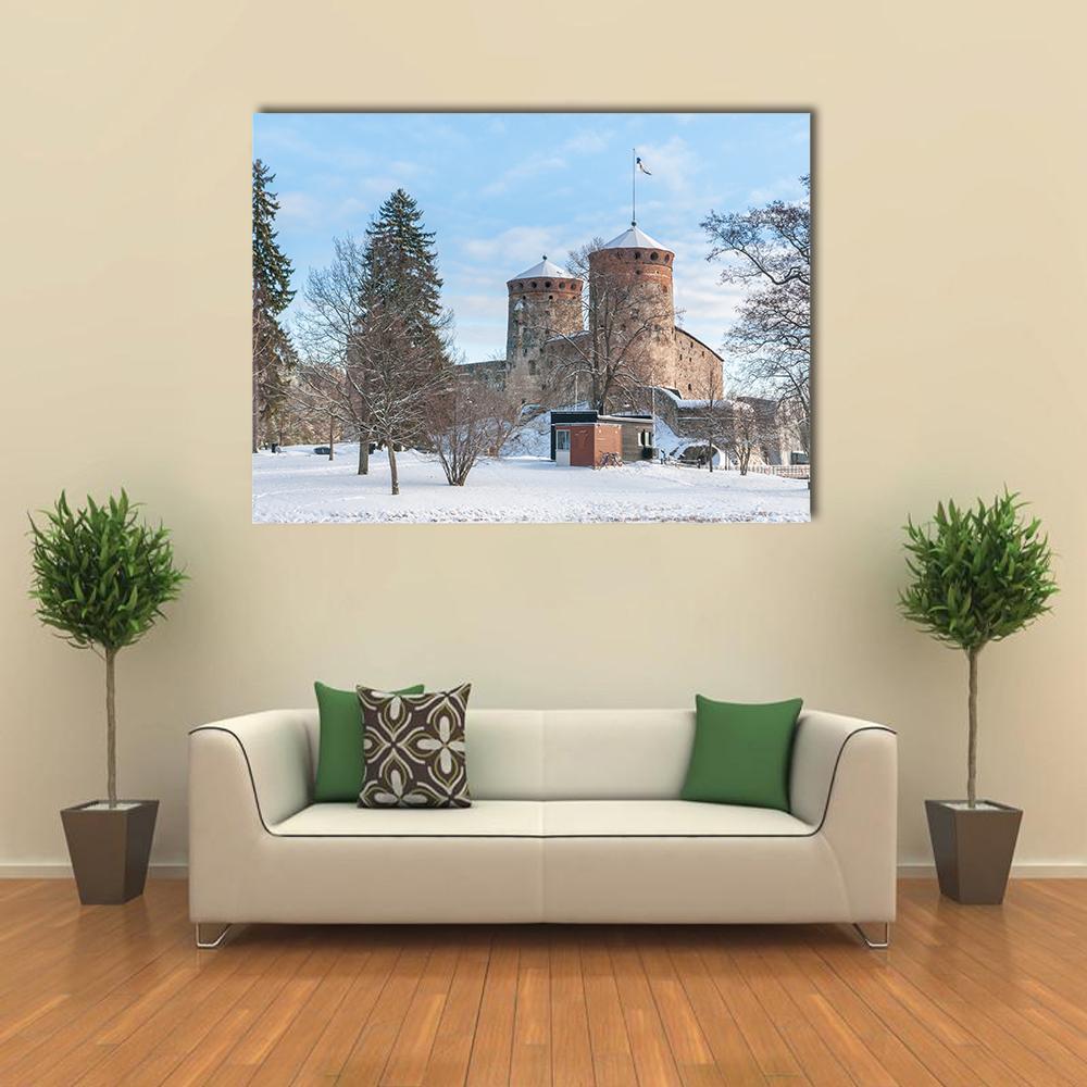 Olavinlinna Castle in Winter Canvas Wall Art in white, brown and blue, single panel hung on a wall
