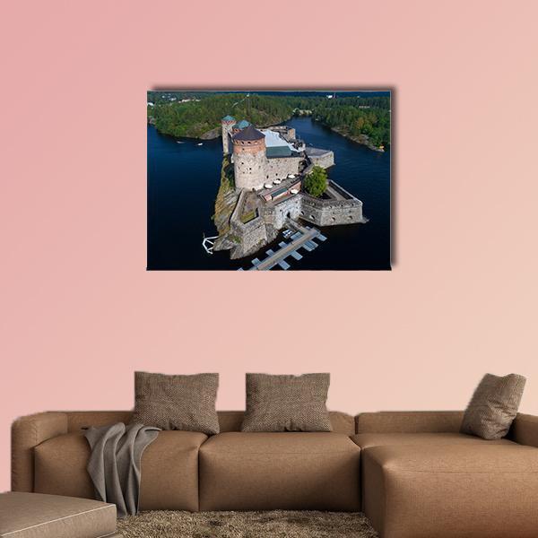 Olavinlinna Fortress on an Island Canvas Wall Art in gray, green and blue, single panel hung on a wall