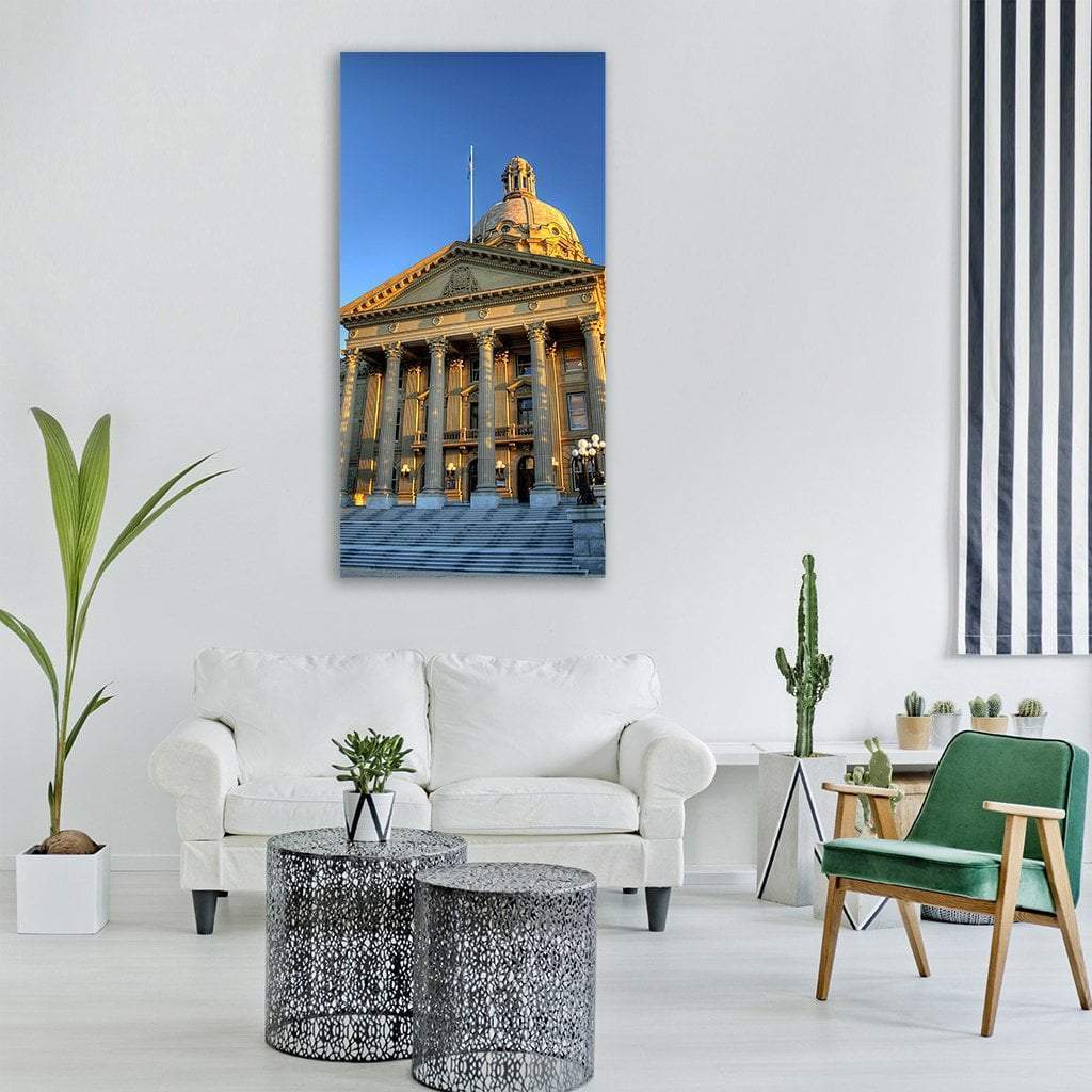 Alberta Legislature Building at Golden Hour Vertical Canvas Wall Art in gold, yellow and blue, single vertical panel hung on a wall
