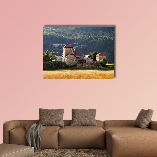 Stone Castle Over Grassy Field Canvas Wall Art in brown, yellow and green, single panel hung on a wall