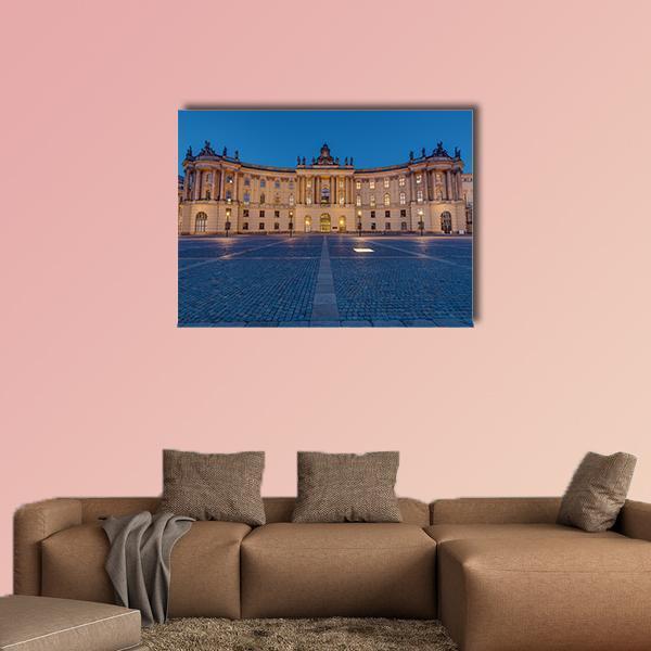 Historic University Building at Night Canvas Wall Art in beige, yellow and blue, single panel hung on a wall