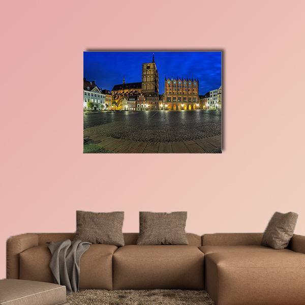 Old Market Square at Twilight Canvas Wall Art in gray, yellow and blue, single panel hung on a wall