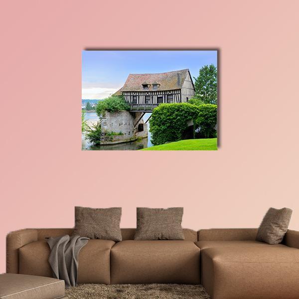 Half-timbered Mill House on Bridge Canvas Wall Art in brown, green and blue, single panel hung on a wall