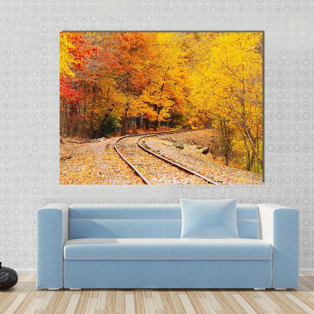 Railroad Track in Autumn Canvas Wall Art in brown, orange and yellow, single panel hung on a wall