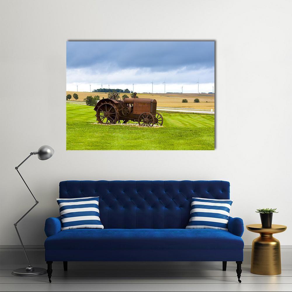 Old Rusty Tractor in Field Canvas Wall Art in brown, green and blue, single panel hung on a wall