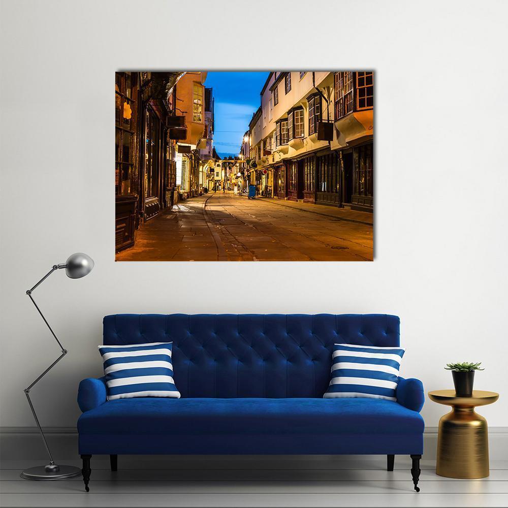 Evening Street View in York Canvas Wall Art in brown, yellow and blue, single panel hung on a wall