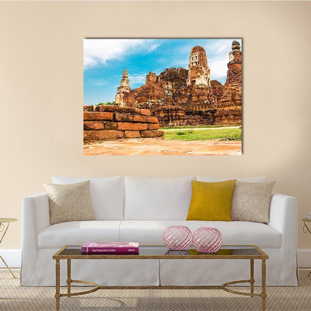 Ayutthaya Temple Ruins Canvas Wall Art in brown, orange and blue, single panel hung on a wall
