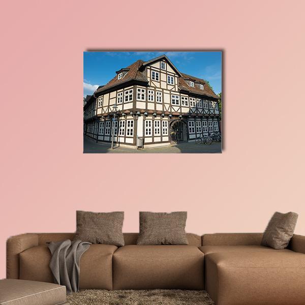 Braunschweig Half-timbered House Canvas Wall Art in beige, brown and blue, single panel hung on a wall