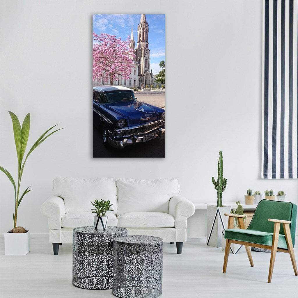 Blue Vintage Car with Church Spire Vertical Canvas Wall Art in white, blue and pink, single vertical panel hung on a wall