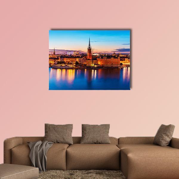 Gamla Stan Waterfront at Dusk Canvas Wall Art in orange, yellow and blue, single panel hung on a wall