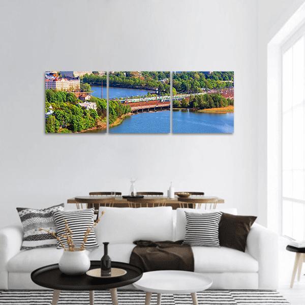 Helsinki Old Town Bridge with Train Panoramic Canvas Wall Art in green and blue, hung on a wall