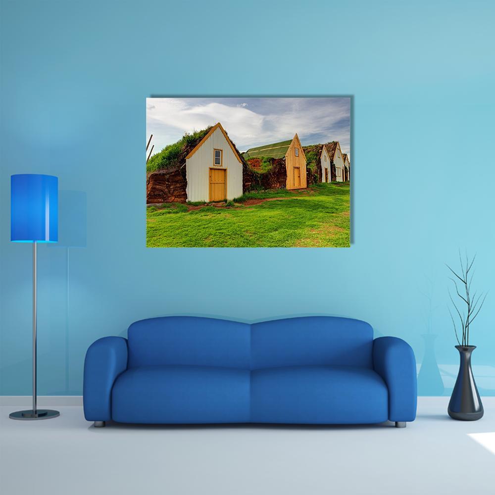 Icelandic Turf-roof Farmhouses Canvas Wall Art in white, green and blue, single panel hung on a wall