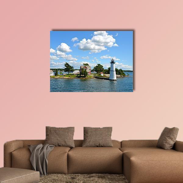 Island Lighthouse and Red-roof House Canvas Wall Art in white, green and blue, single panel hung on a wall