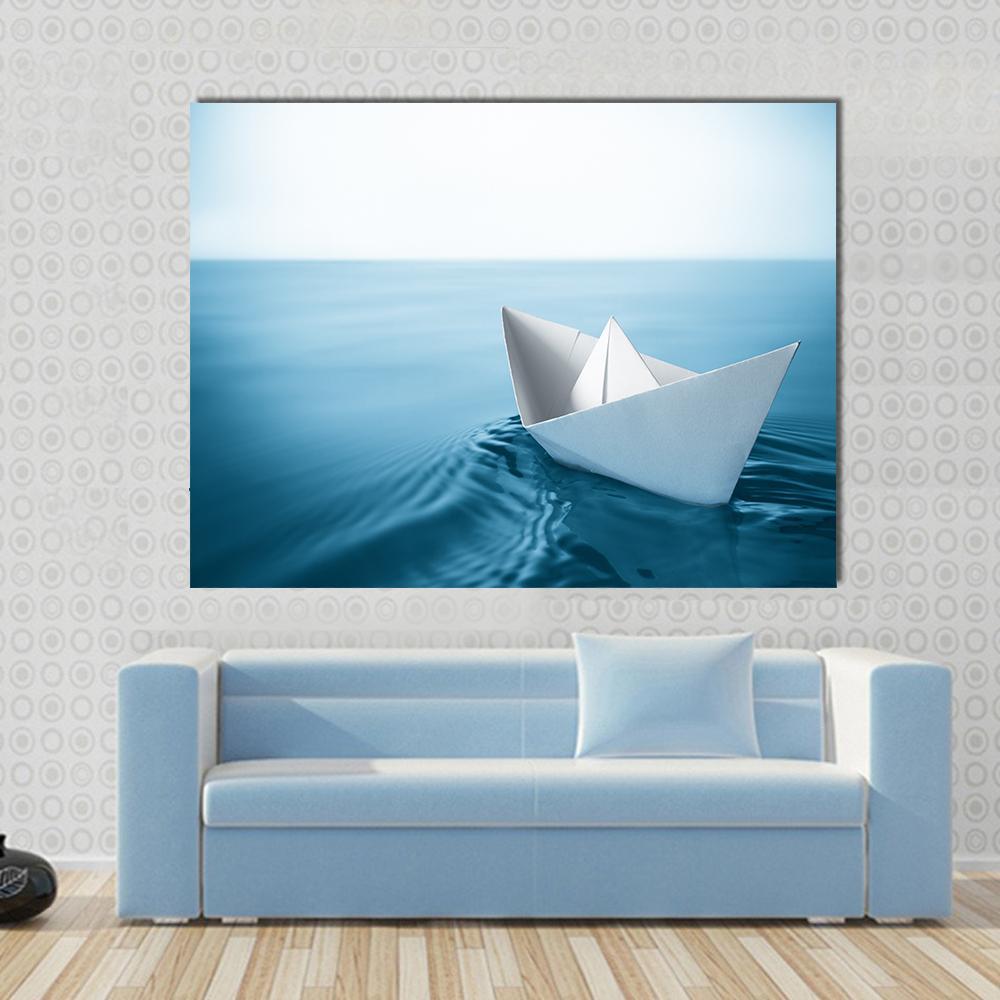 Paper Sailboat in Water Canvas Wall Art in white and blue, single panel hung on a wall