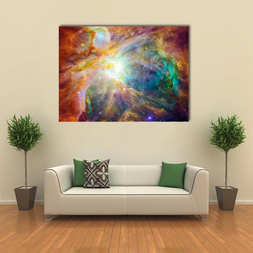 Orion Nebula Cosmic Cloud Canvas Wall Art in orange, blue and multicolor, single panel hung on a wall
