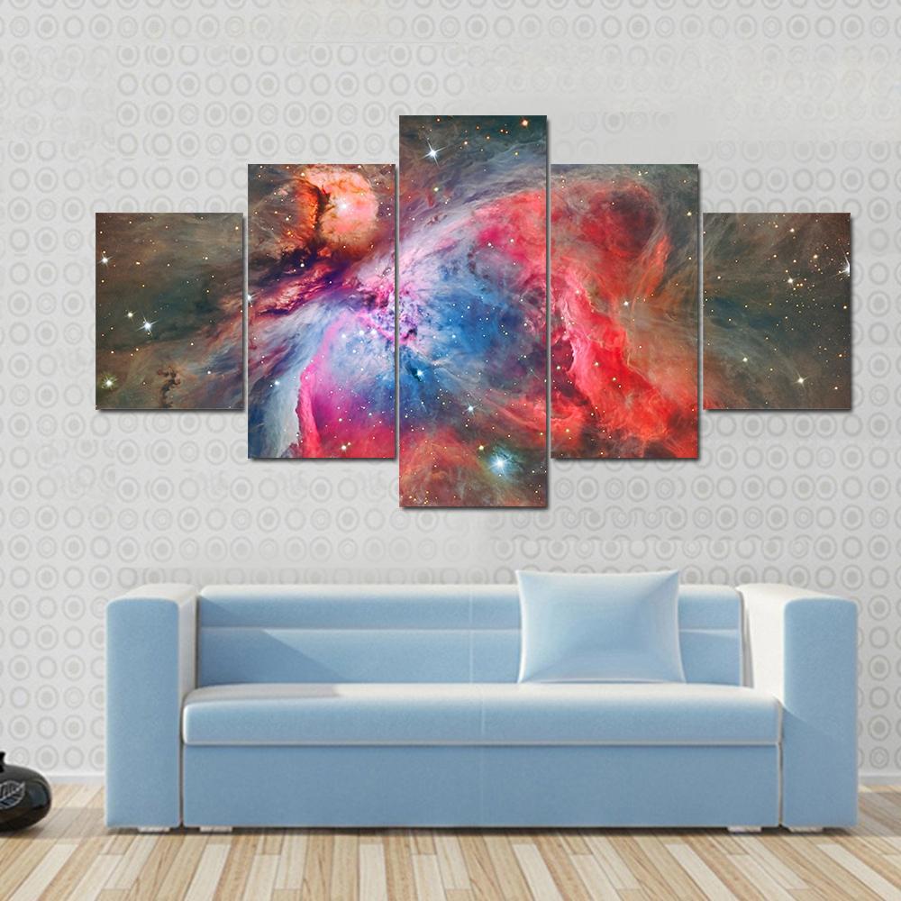 Orion Nebula Canvas Wall Art in black, red and blue, 5 panel Star layout hung on a wall