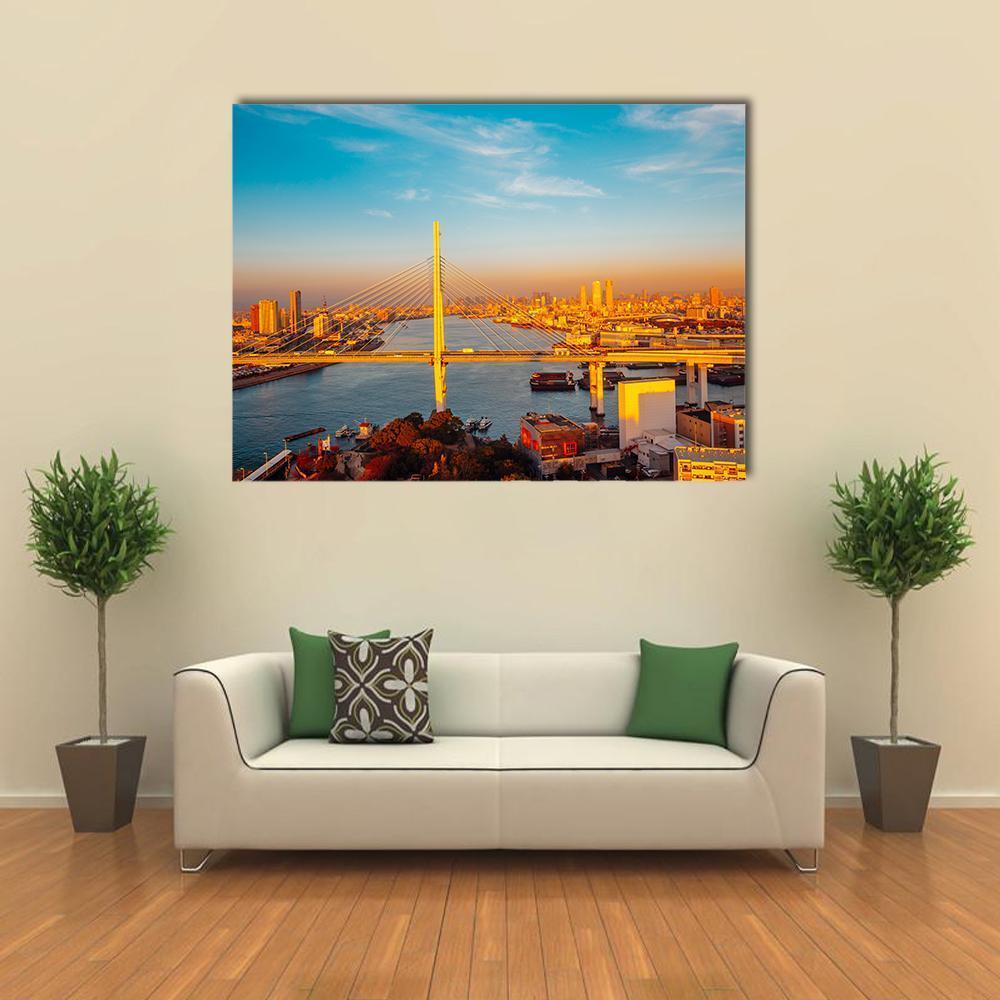 Osaka Port Bridge and Cityscape Canvas Wall Art in orange, yellow and blue, single panel hung on a wall