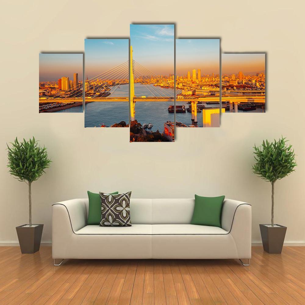 Osaka Port Bridge and Cityscape Canvas Wall Art in orange, yellow and blue, 5 panel Star layout hung on a wall