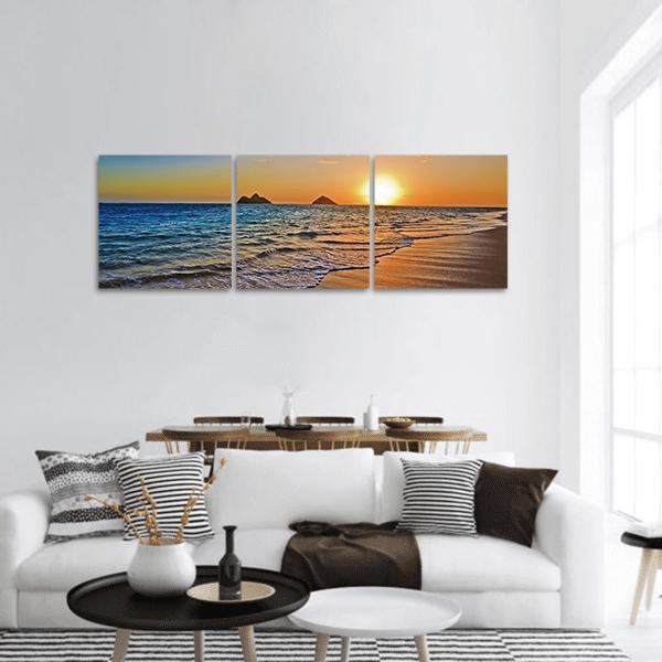 Sunset Beach with Two Offshore Islands Panoramic Canvas Wall Art in orange, yellow and blue, hung on a wall