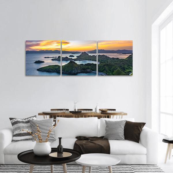 Padar Island at Sunset Panoramic Canvas Wall Art in orange, green and blue, hung on a wall