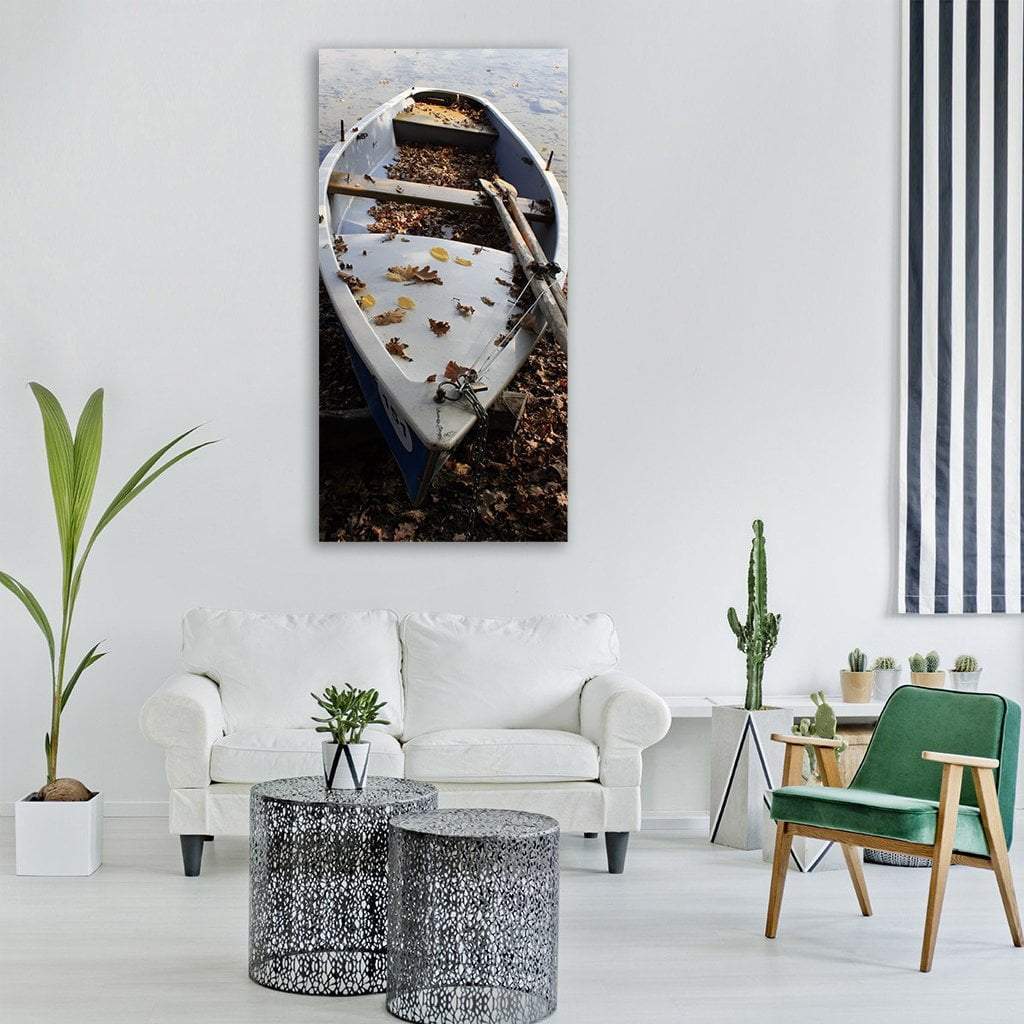 Paddle Boat in Fall Foliage Vertical Canvas Wall Art in gray, brown and blue, single vertical panel hung on a wall