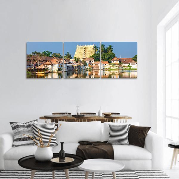 Padmanabhaswamy Temple Reflected on Lake Panoramic Canvas Wall Art in beige, gold and blue, hung on a wall