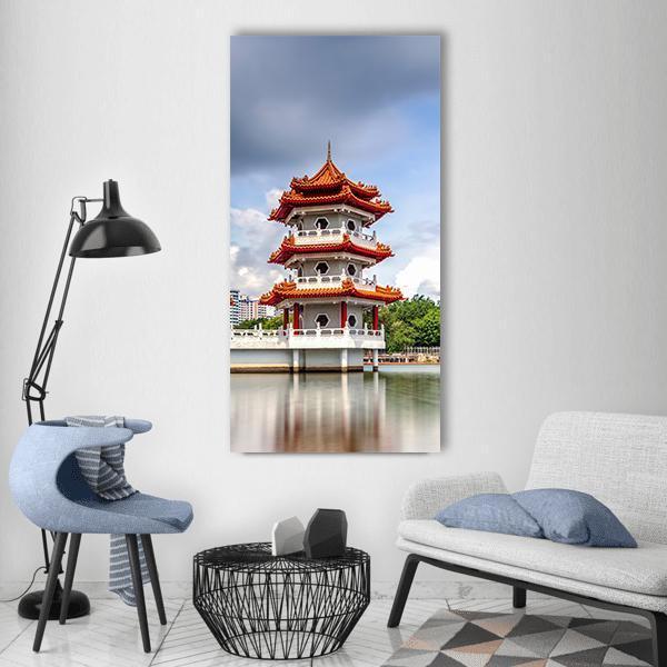 Twin Pagoda with Water Reflection Vertical Canvas Wall Art in gray, orange and blue, single vertical panel hung on a wall