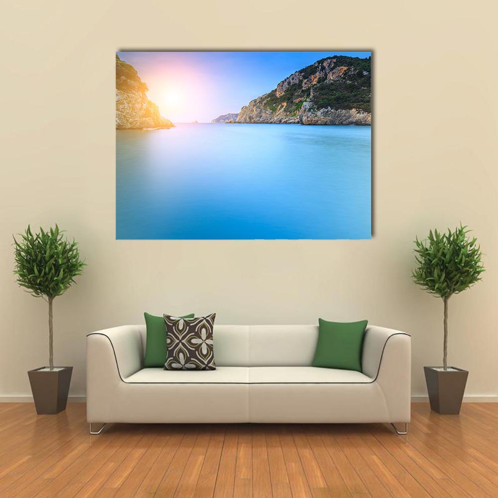 Paleokastritsa Sand Beach at Sunrise Canvas Wall Art in orange, yellow and blue, single panel hung on a wall