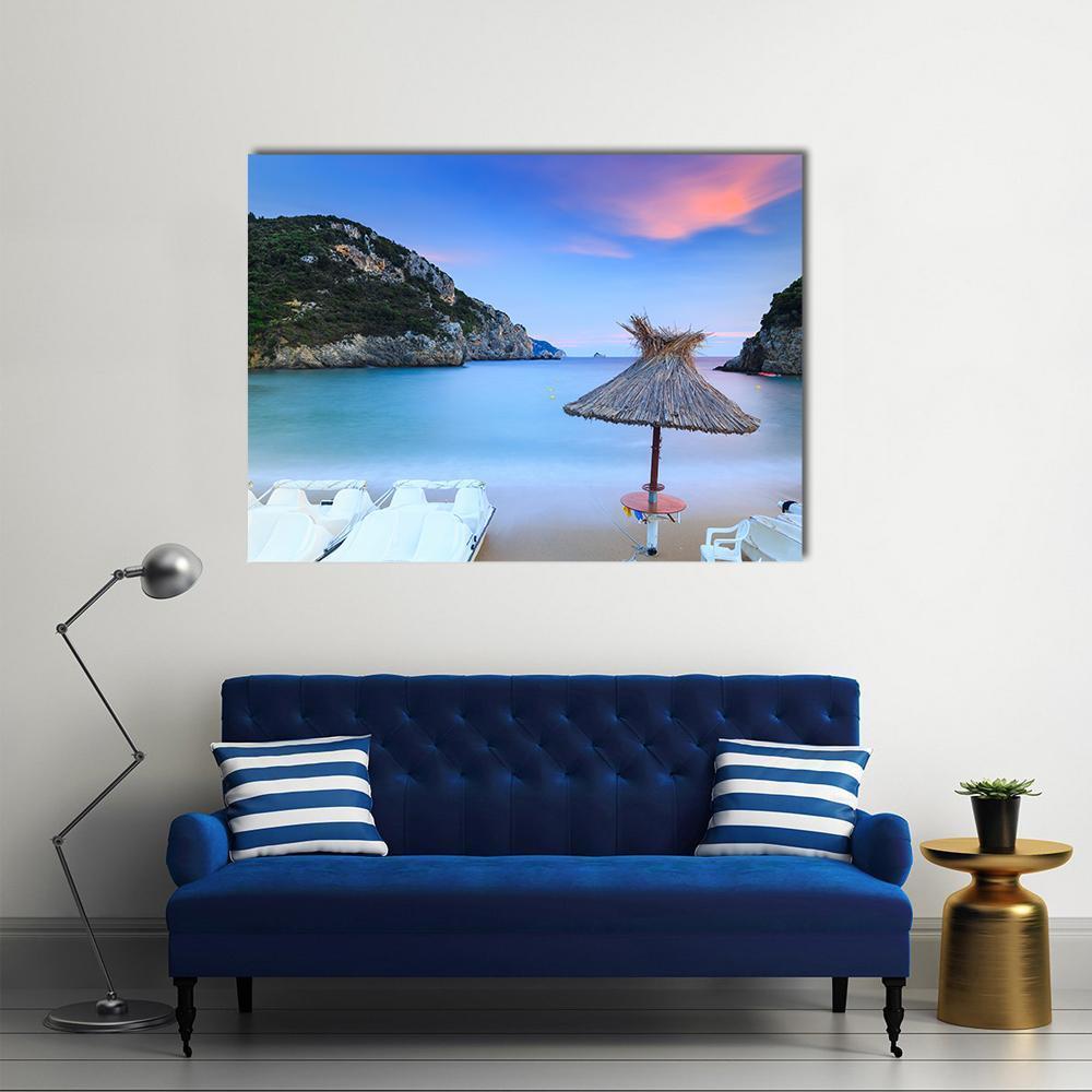 Paleokastritsa Sand Beach at Dusk Canvas Wall Art in beige, blue and pink, single panel hung on a wall