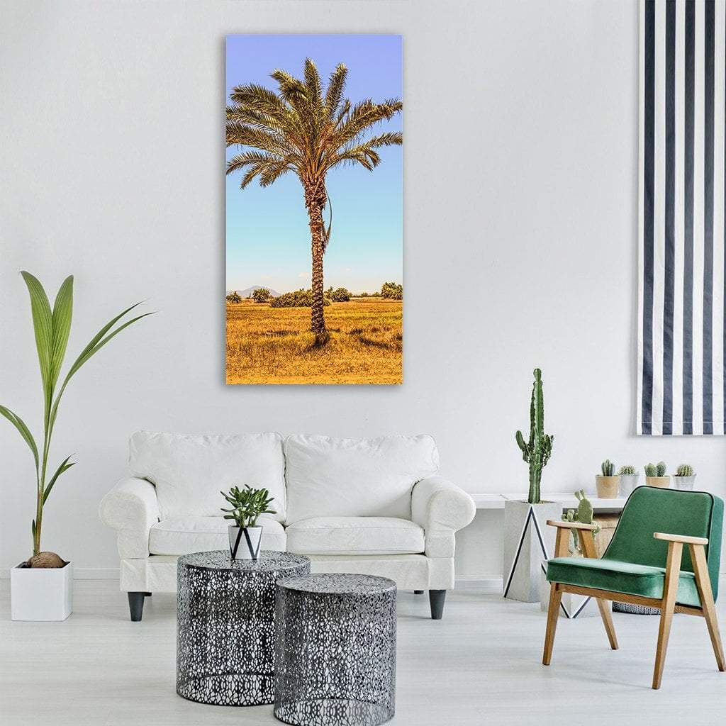 Palm Tree in Golden Field Vertical Canvas Wall Art in gold, yellow and blue, single vertical panel hung on a wall