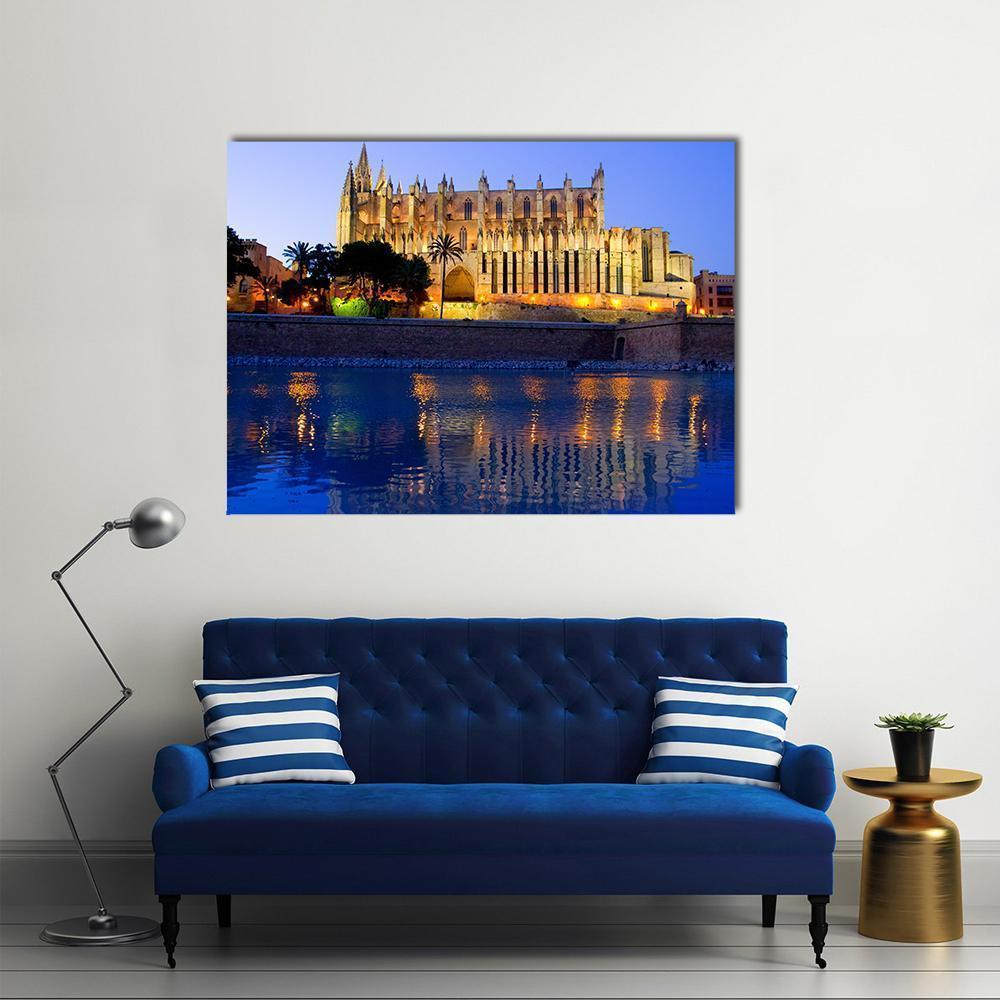 Palma Cathedral Reflected at Night Canvas Wall Art in gold, yellow and blue, single panel hung on a wall