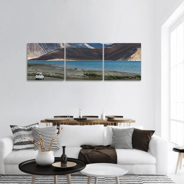 Pangong Lake Turquoise Shoreline Panoramic Canvas Wall Art in gray, brown and blue, hung on a wall