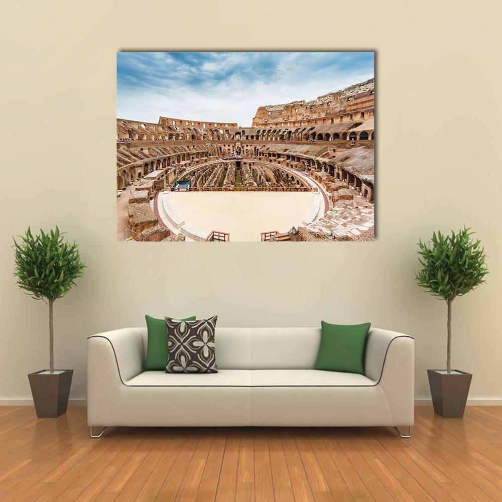 Colosseum Interior, Rome Canvas Wall Art in beige, brown and blue, single panel hung on a wall