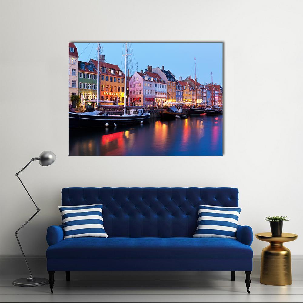 Vibrant Nyhavn Harbor Scene in Copenhagen Canvas Wall Art in red, yellow and blue, single panel hung on a wall