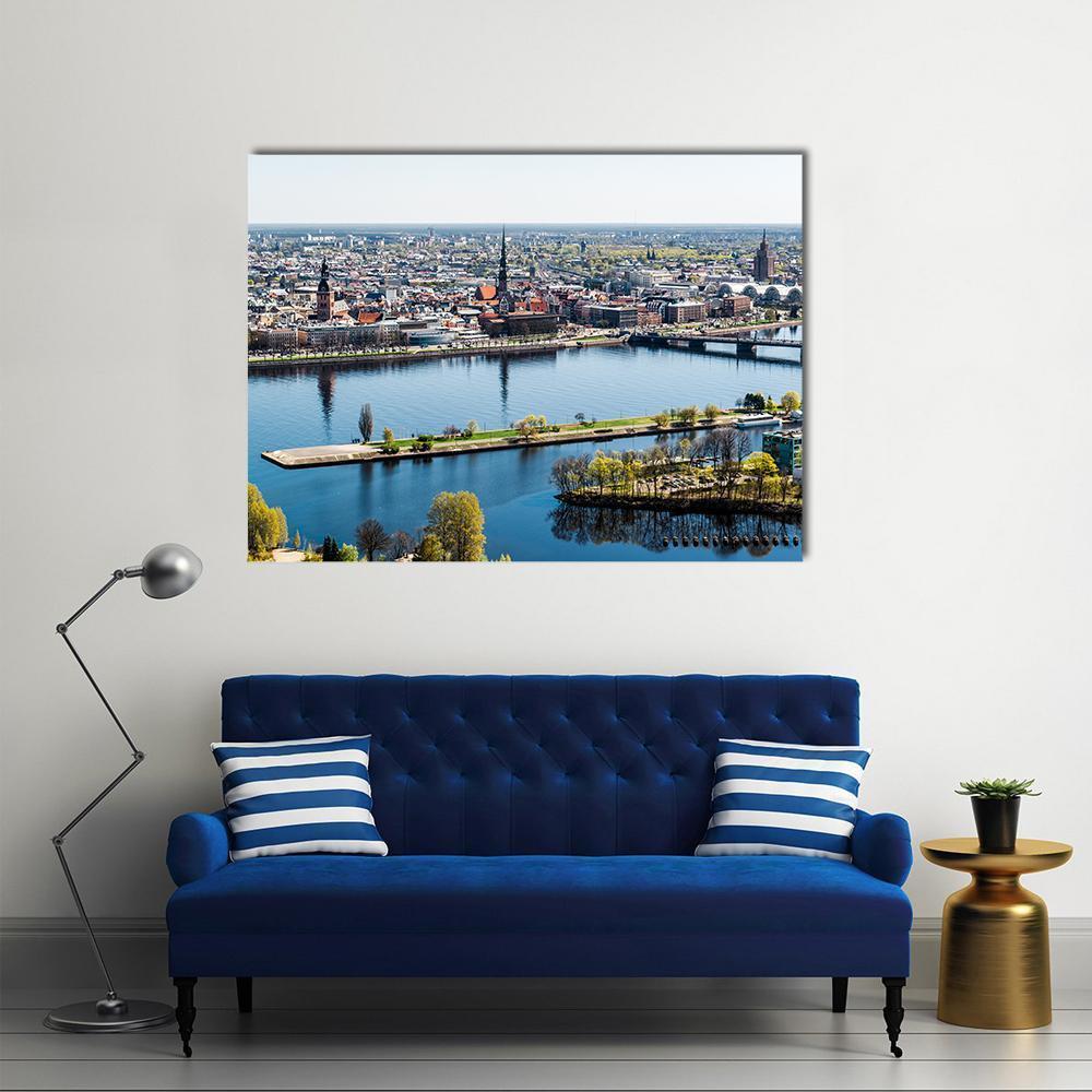 Riga Skyline with River Reflections Canvas Wall Art in gray, green and blue, single panel hung on a wall