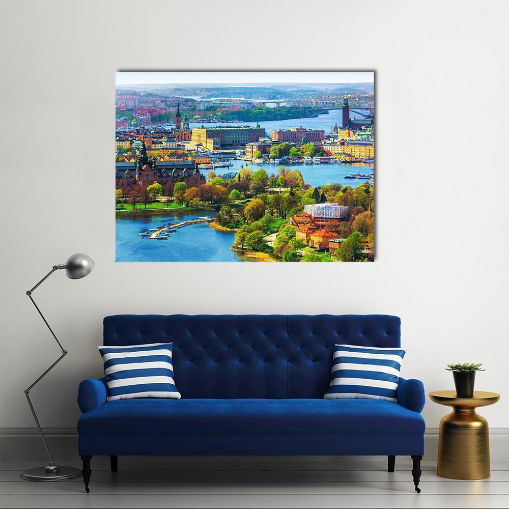 Old Town Waterfront Cityscape Canvas Wall Art in orange, green and blue, single panel hung on a wall