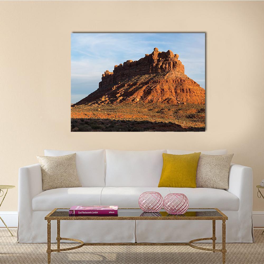 Desert Rock Formation in Late Afternoon Light Canvas Wall Art in brown, orange and blue, single panel hung on a wall