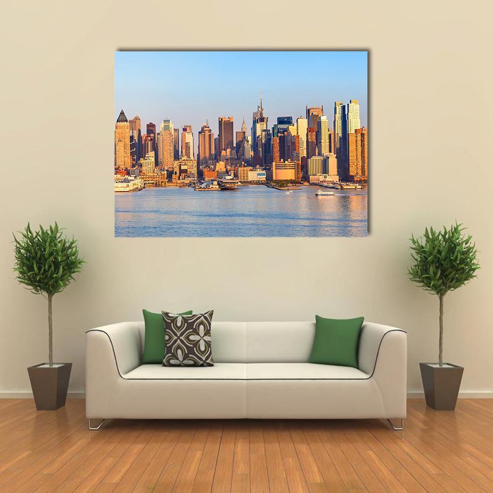 Manhattan Waterfront Skyline Canvas Wall Art in orange, yellow and blue, single panel hung on a wall