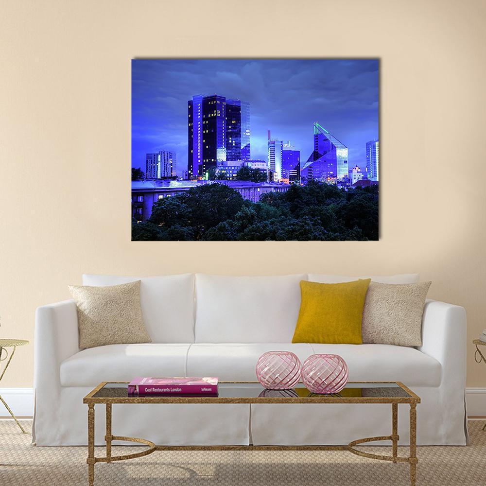 Tallinn Night Skyline Canvas Wall Art in black, blue and purple, single panel hung on a wall