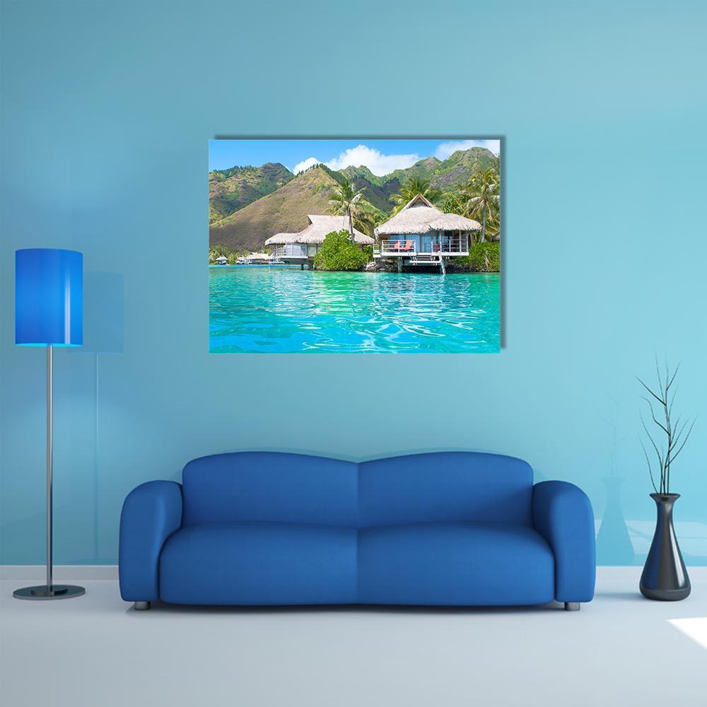 Paradise Overwater Bungalows Canvas Wall Art in brown, green and blue, single panel hung on a wall