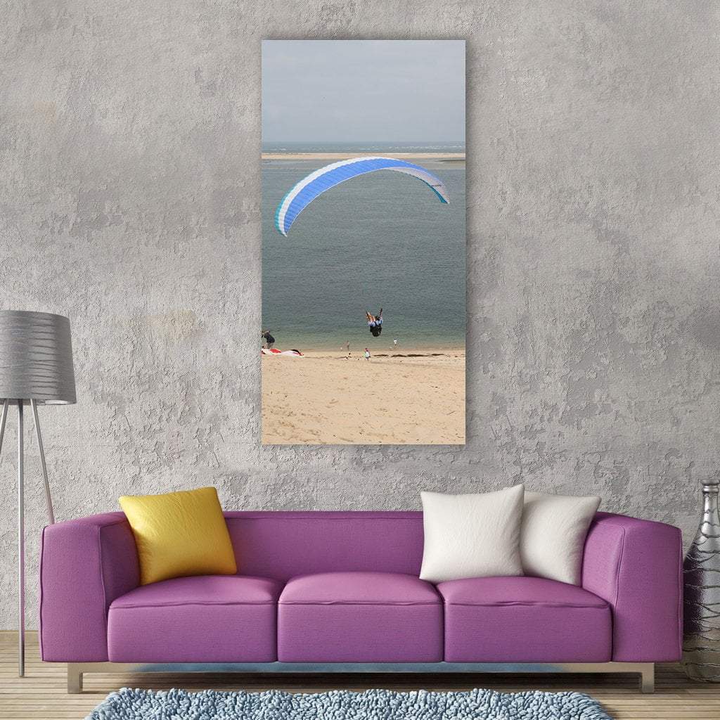 Paraglider Over Beach Vertical Canvas Wall Art in gray, beige and blue, single vertical panel hung on a wall