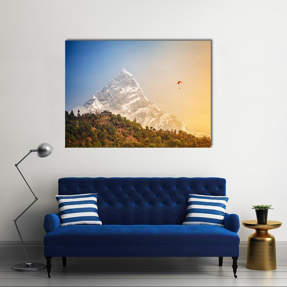 Paragliding Near Machhapuchhre Mountain Canvas Wall Art in white, orange and blue, single panel hung on a wall
