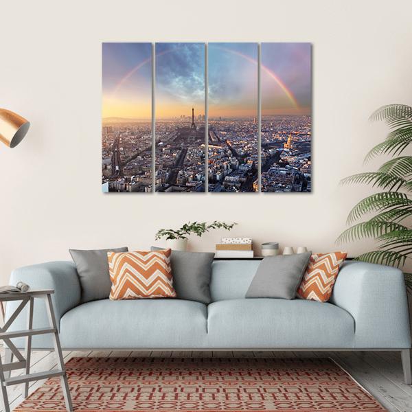 Paris Skyline with Rainbow at Sunset Canvas Wall Art in orange, yellow and blue, hung on a wall