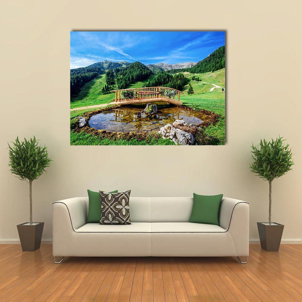 Italian Park with Wooden Bridge and Pond Canvas Wall Art in brown, green and blue, single panel hung on a wall