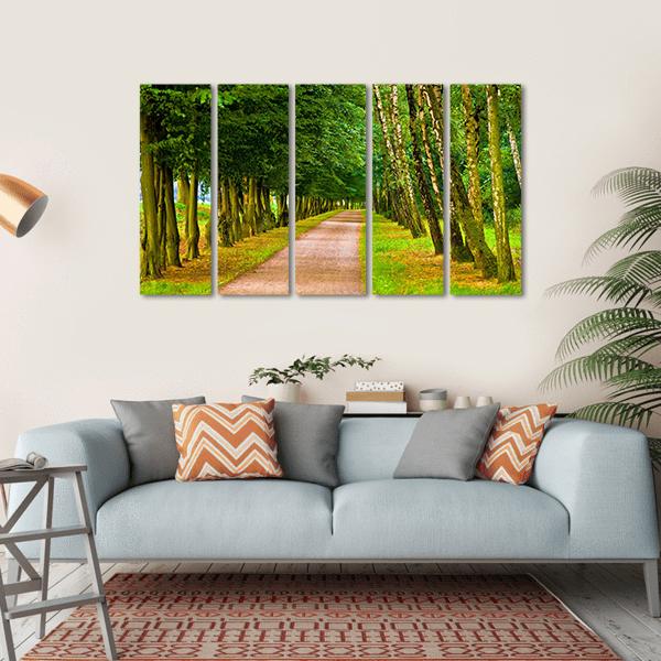 Spring Park Tree-lined Path Canvas Wall Art in brown, yellow and green, single panel hung on a wall