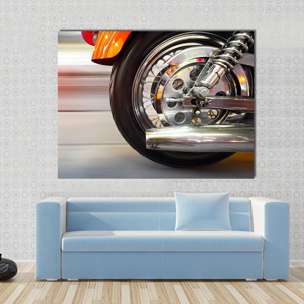Luxury Motorcycle with Blurry Asphalt Road Canvas Wall Art in black, silver and orange, single panel hung on a wall