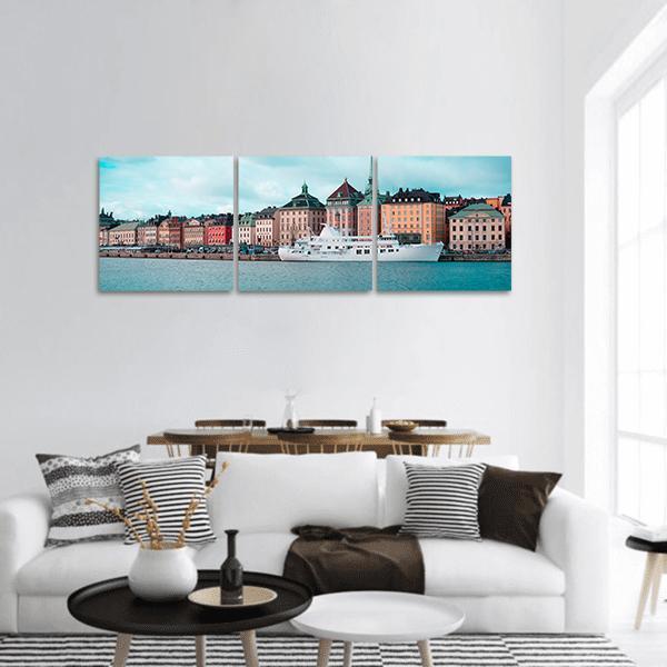Passenger Ship in Stockholm Harbor Panoramic Canvas Wall Art in white, orange and blue, hung on a wall